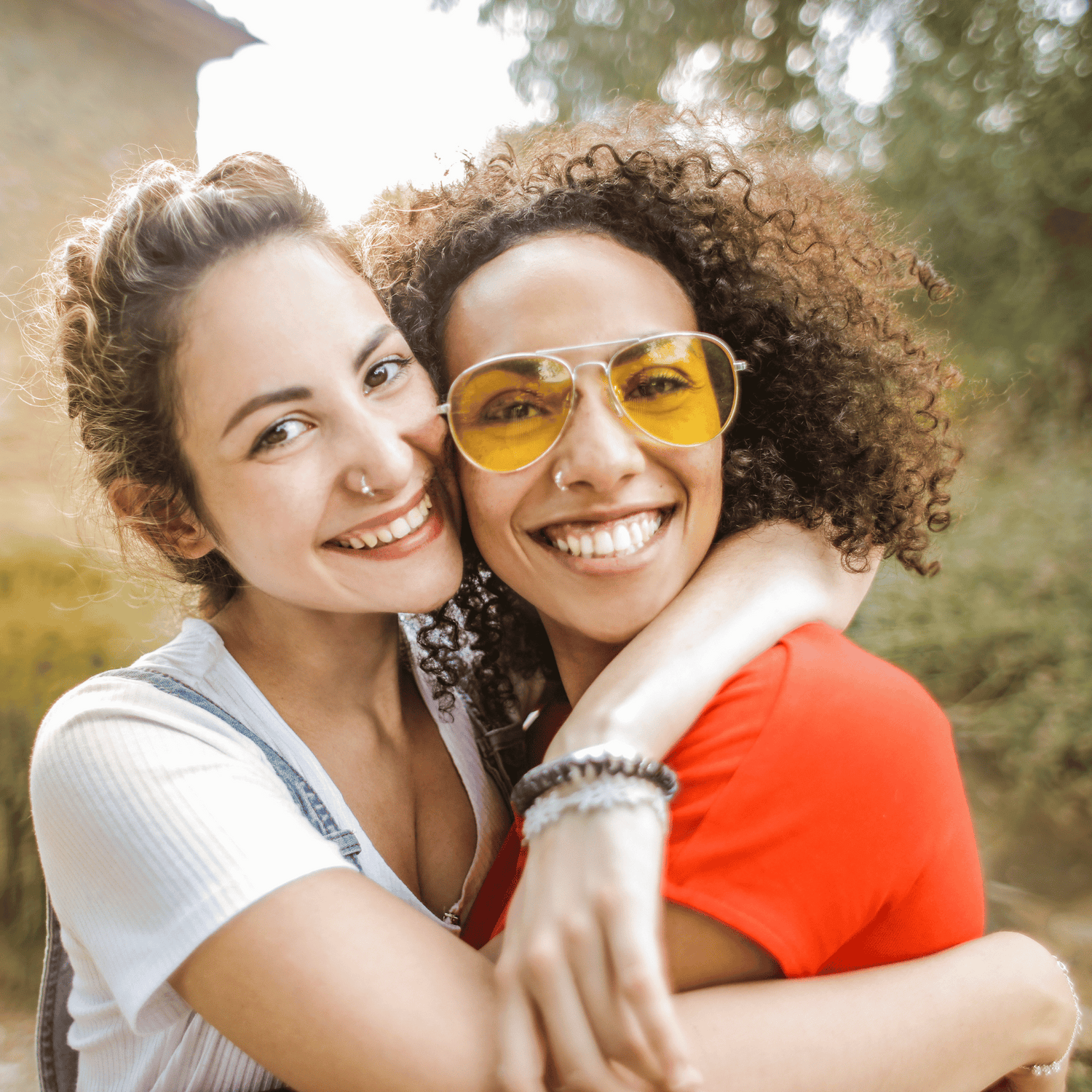 Twee jonge vrouwen die elkaar omhelzen.