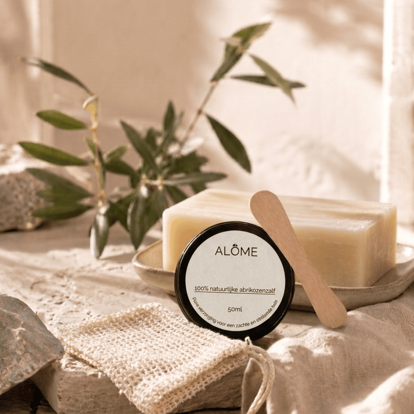Minimalistische skincareroutine met abrikozenzalf, crèmespatel, shea butter zeep en zeepzakje