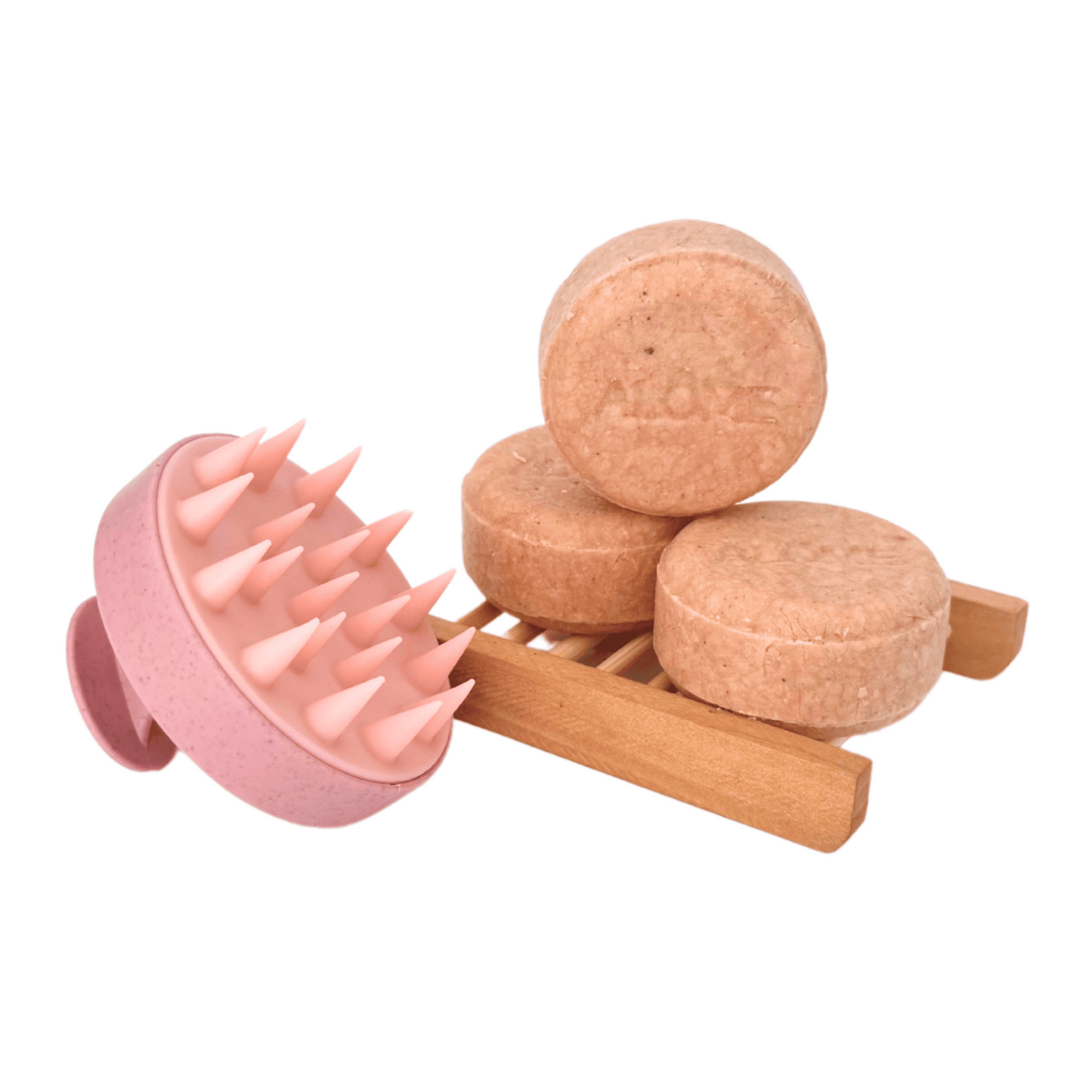 Normaal haar shampoo bars op zeepschaaltje en roze massageborstel